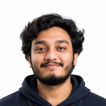 Portrait of Imran Shaik smiling, wearing a navy hoodie.